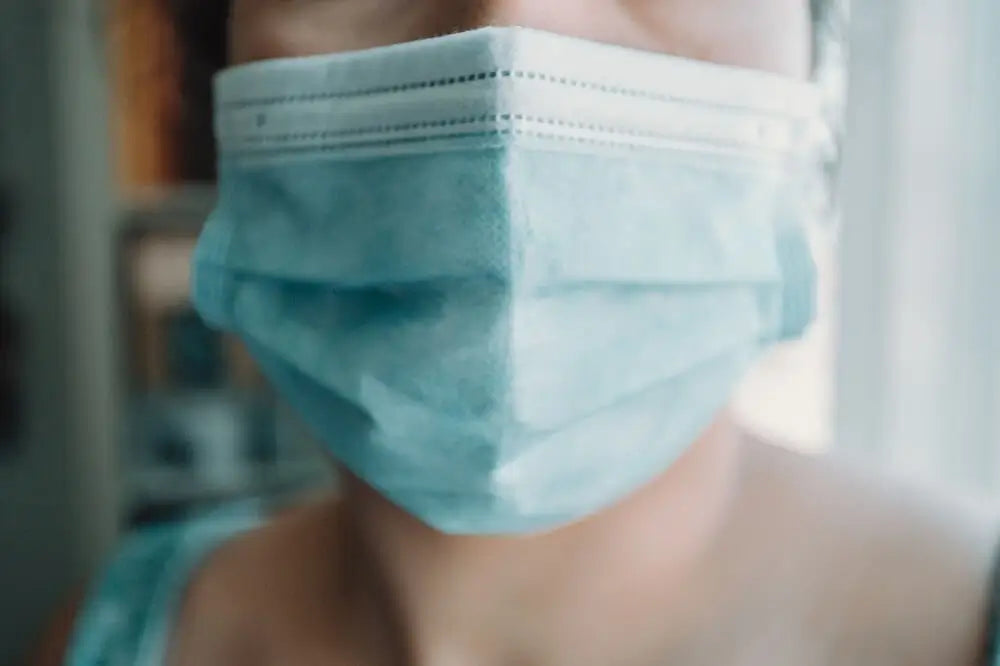 Person wearing surgical mask close-up